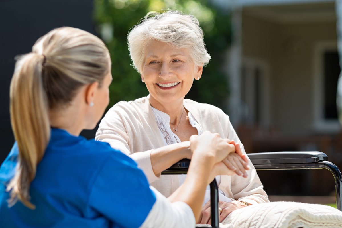 Nurse speaking with smiling patient
